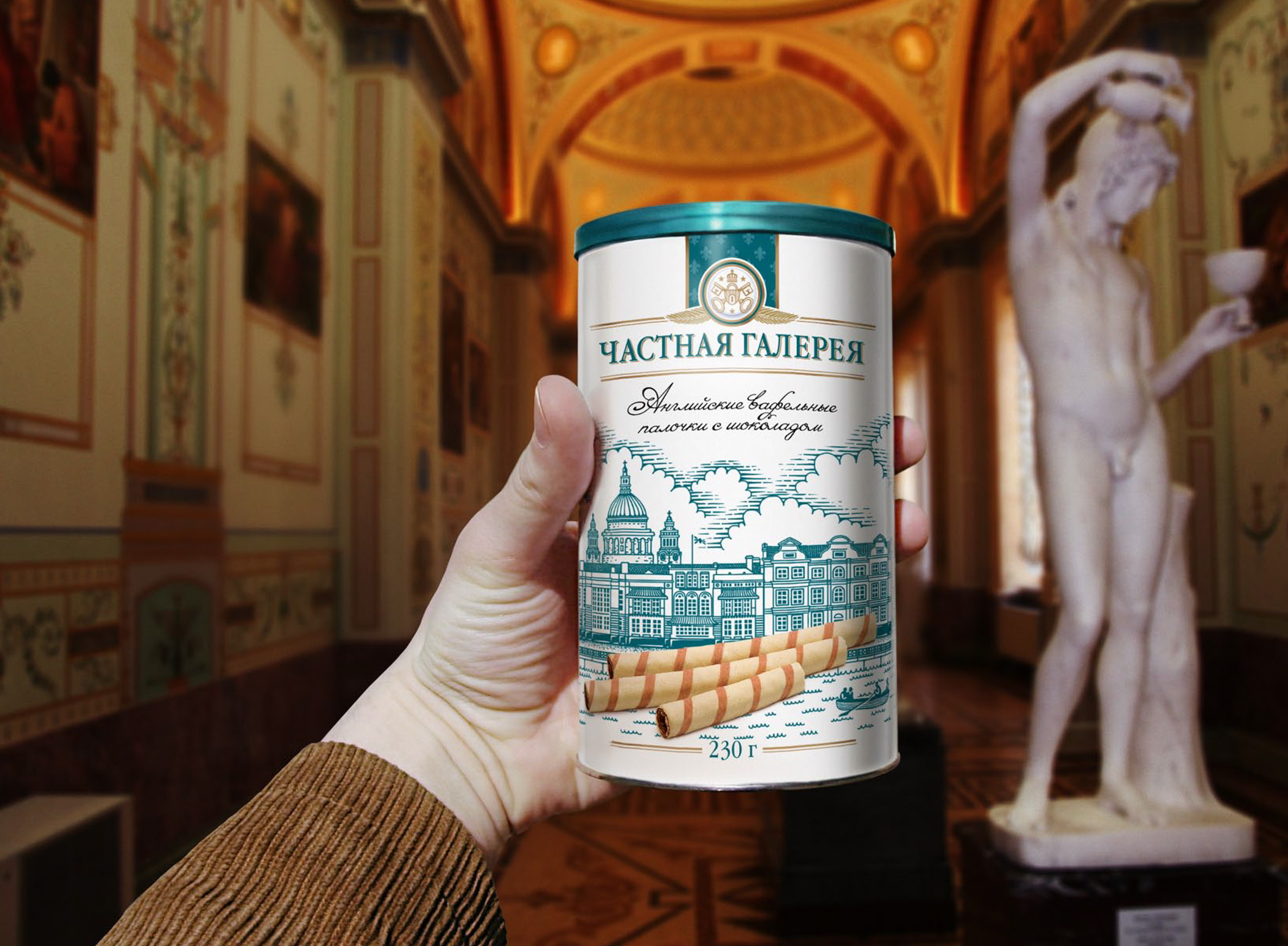 Hand holding a Chastnaya Galereya tin of chocolate wafer sticks inside an ornate gilded gallery hall.