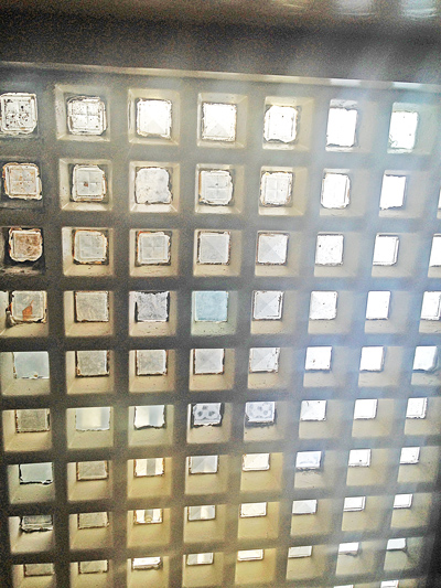 Grid of glass blocks in a wall letting through daylight
