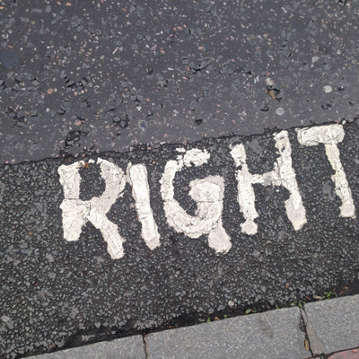 The word 'RIGHT' painted in white on the asphalt of a road